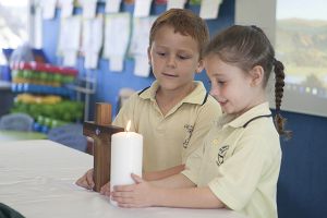 St Mary - St Joseph Catholic Primary School Maroubra - students holding a candle and crucifix